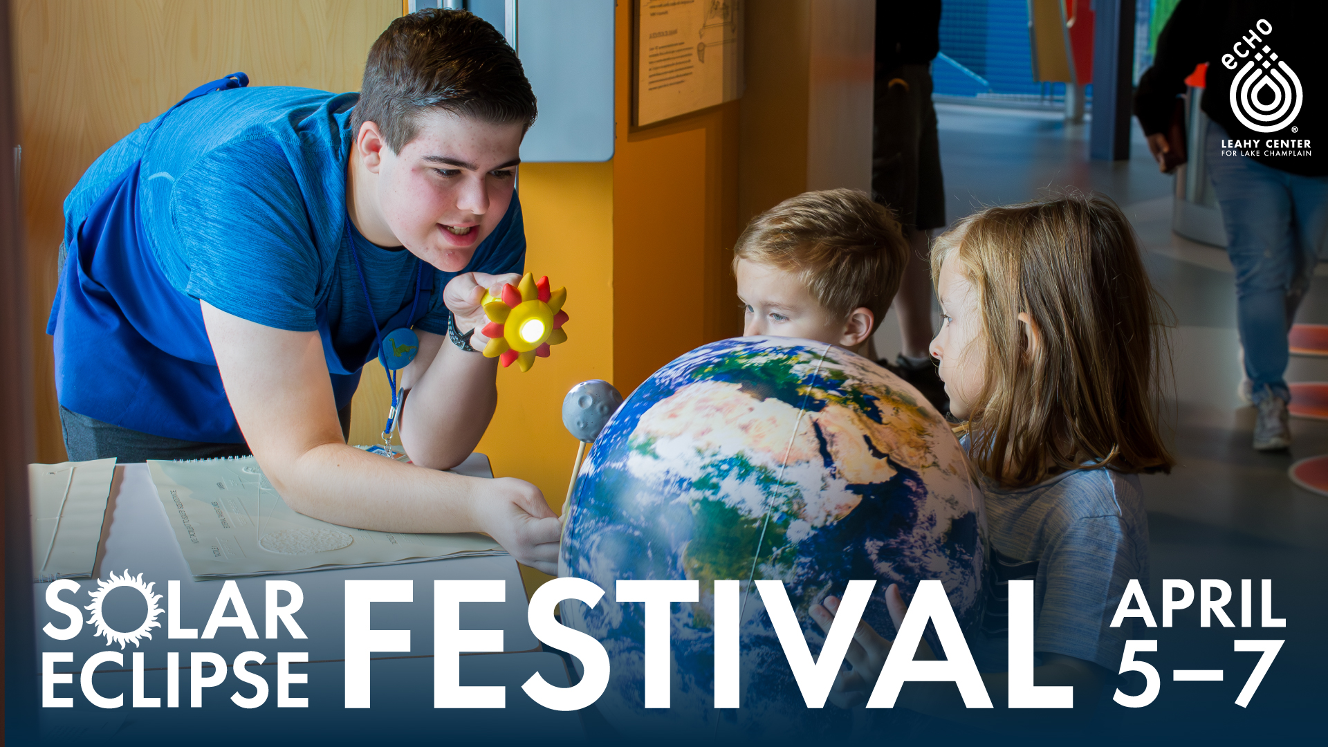 A photo of an ECHO intern using a flashlight to simulate an eclipse against an inflatable Earth held by two young guests. White text reads Solar Eclipse Festival April 5-7