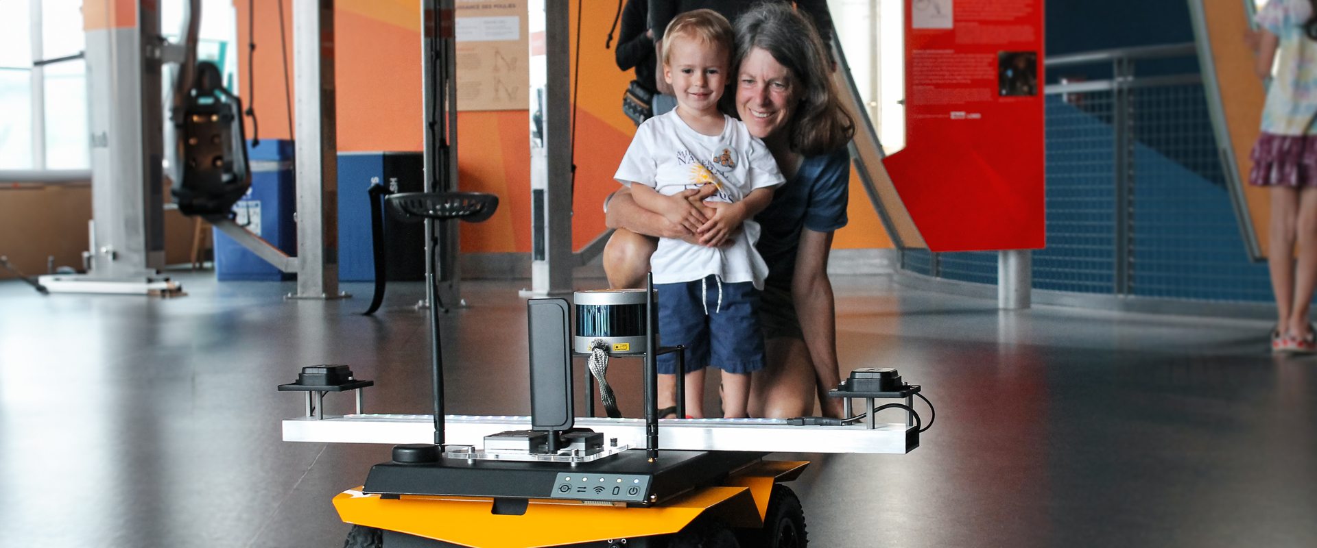 Parent and child look excited at a robot at ECHO