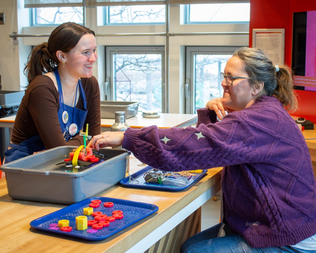 An ECHO teen intern and an adult work together to solve ECHO's Float Your Boat engineering challenge.